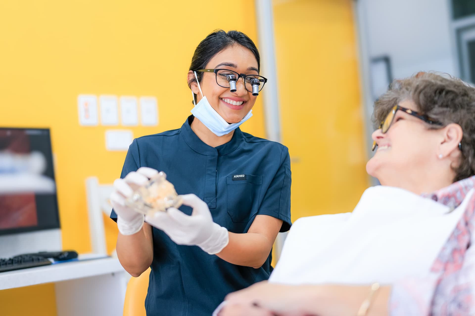 A dentist and patient reviewing imaging results together at Sienna Smiles